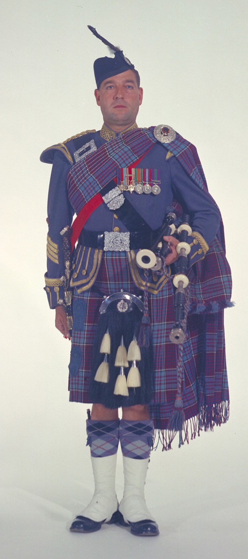 Pipe Major John T. Mackenzie attired in full regalia with pipes, wearing the RCAF tartan, in an undated photo. He was the Pipe Major of the Scots Guards before emigrating and enrolling in the RCAF. PHOTO: RNC-1127-4, DND Archives
