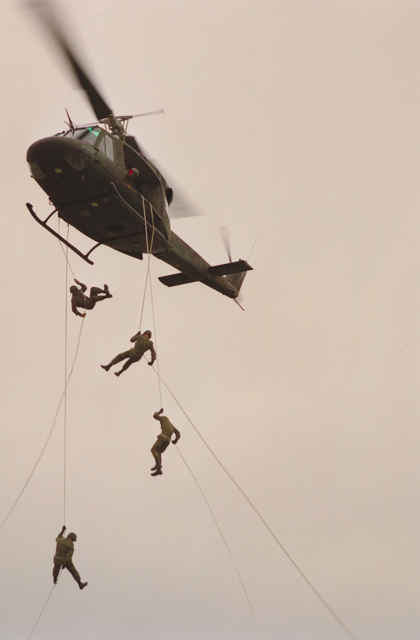 Soldiers rappel from a 450 Squadron CH-135 Twin Huey helicopter in a 1988 photo. PHOTO: ISC88-127, by Warrant Officer Vic Johnson