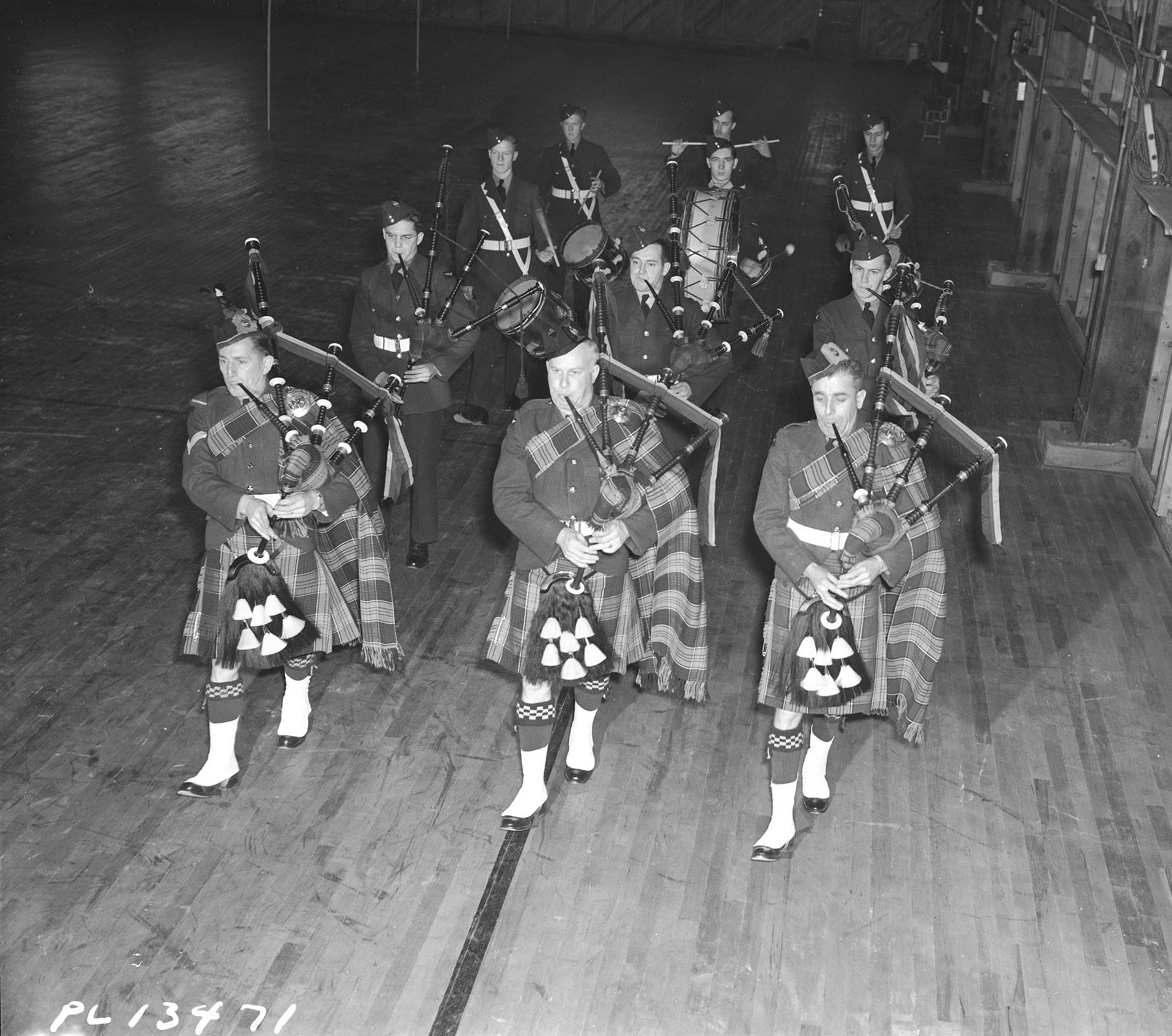 Members of the No. 9 Service Flying Training School Pipe Band in Centralia, Ontario, parade in full regalia on February 24, 1943. PHOTO: DND Archives, PL-13471