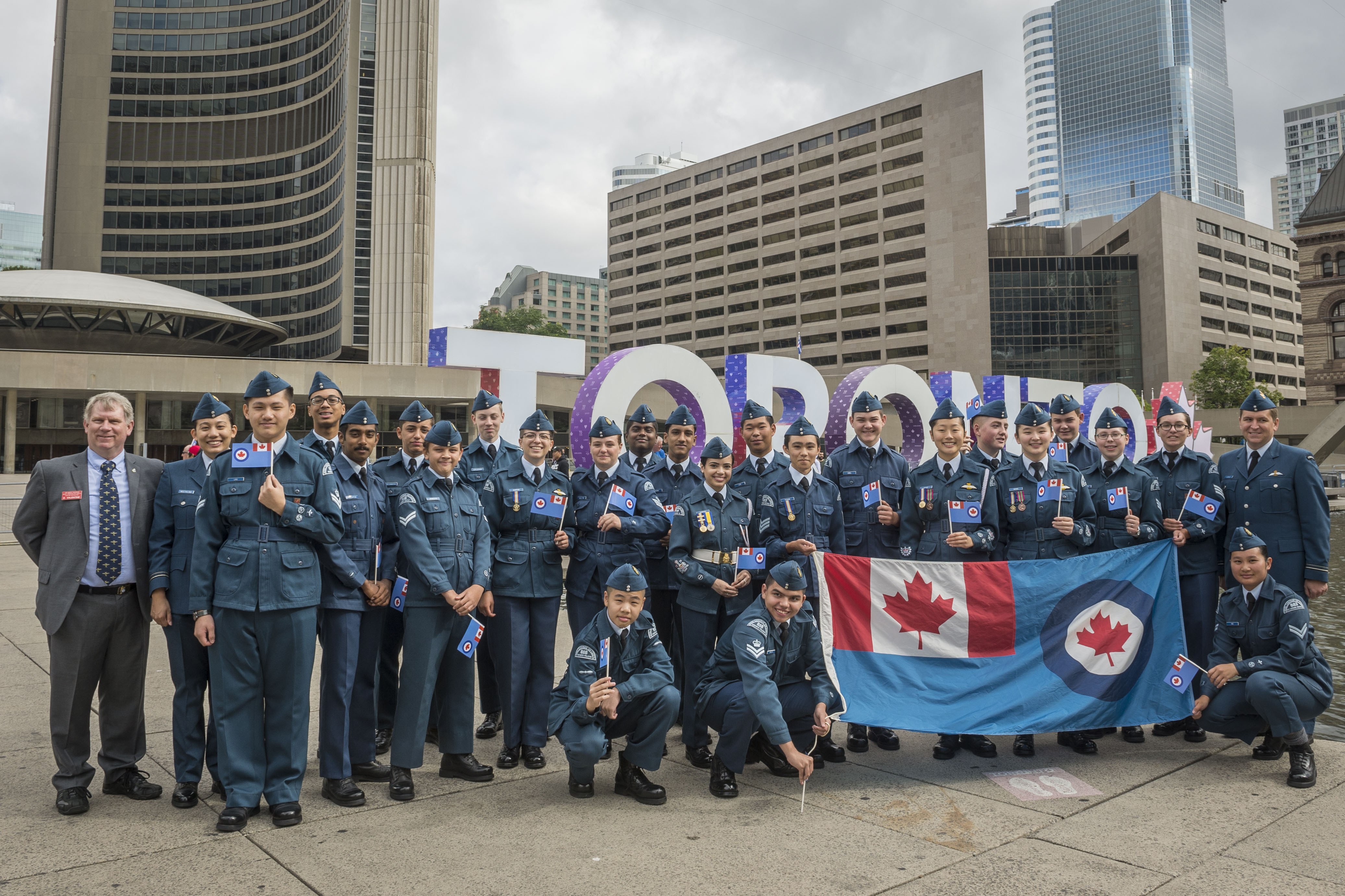 On August 31, 2017, Royal Canadian Air Force Cadets celebrate at the TORONTO sign at Nathan Phillips Square to mark the presentation of new Colours to the RCAF on September 1, also at Nathan Phillips Square. #RCAFProud PHOTO: Corporal Alana Morin, FA03-2017-0109-011