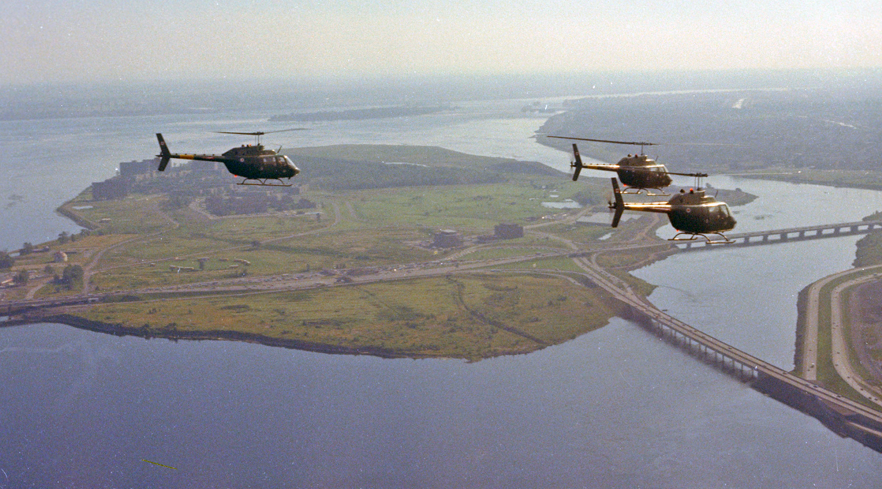 Three 427 Squadron CH-136 Kiowa helicopters from Petawawa, Ontario, fly over Nun's Island in Montreal during Exercise Power Play in August 1974. 427 Squadron began operating CH-136 Kiowa light observation helicopters in the 1970s. PHOTO: DND Archives, IMC74-123