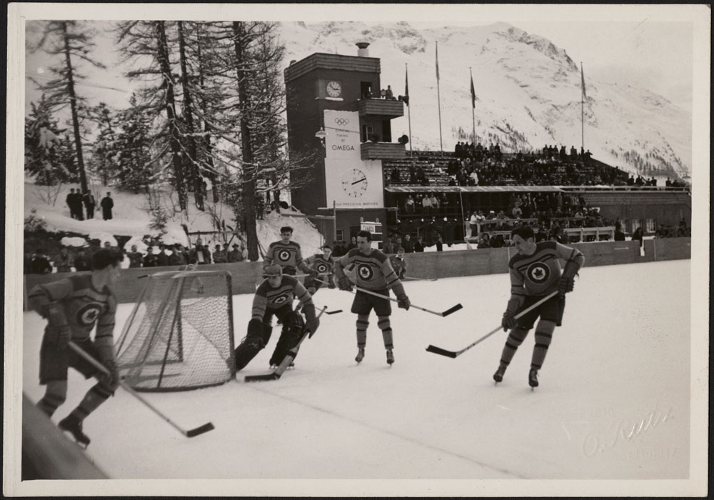 The RCAF Flyers hockey team in action against Sweden's national men's hockey team at the 1948 Winter Olympic Games in St. Moritz, Switzerland. PHOTO: LAC MIKAN no. 4842046 