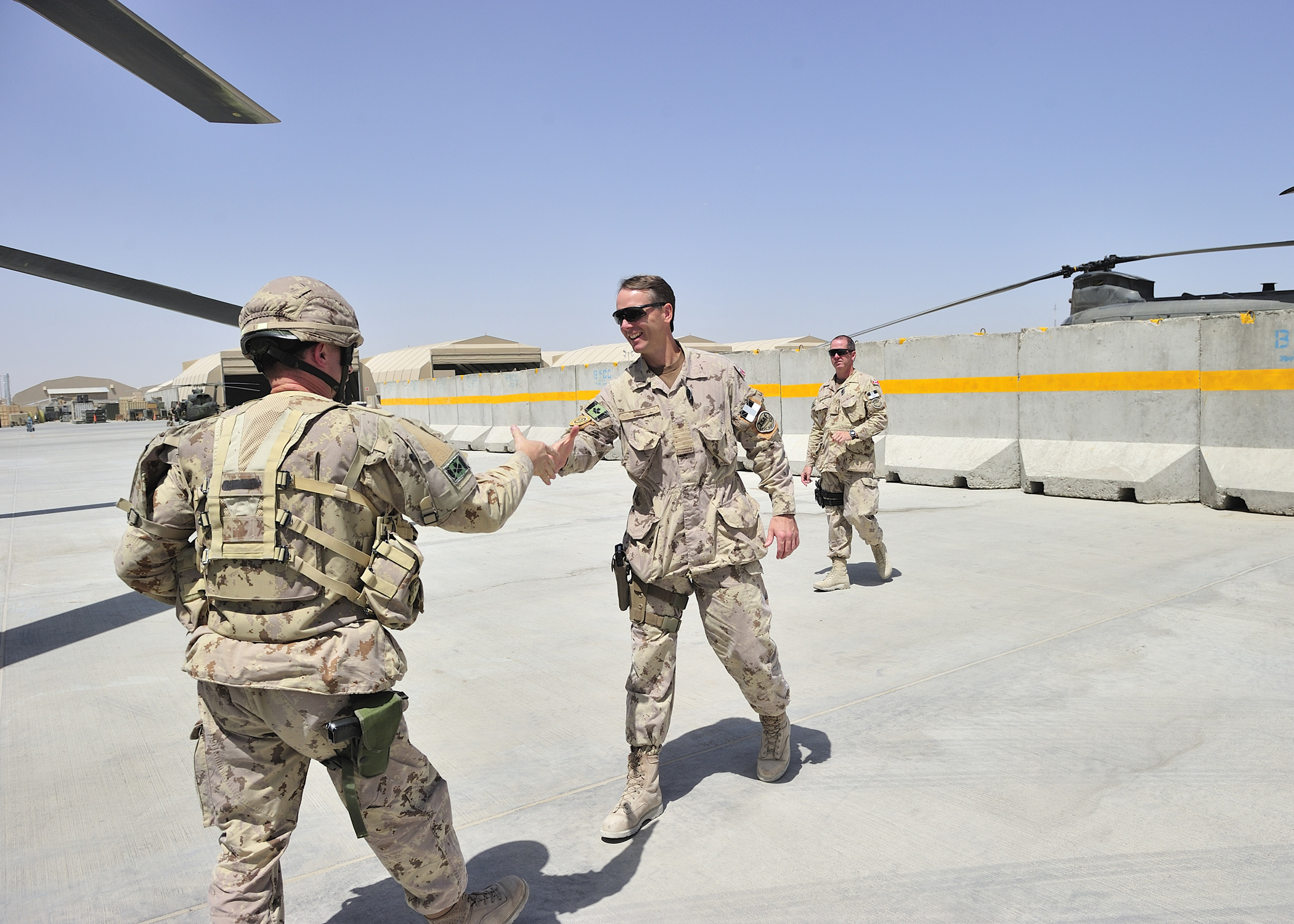 Colonel Al Meinzinger (right), commander of the Air Wing, Task Force Silver Dart, greets Brigadier-General Charles Lamarre, commander of the Mission Transition Task Force, on 22 July 22, 2011, in Kandahar, Afghanistan. On May 4, 2018, now-Lieutenant-General Meinzinger took command of the Royal Canadian Air Force. PHOTO: Master Corporal Dan Shouinard, AR2011-0294-124