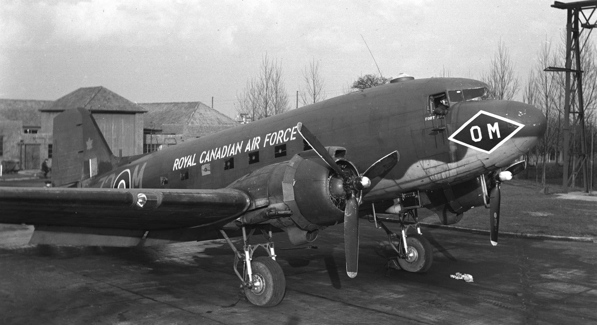 A large propeller driven aircraft rests on the tarmac. 