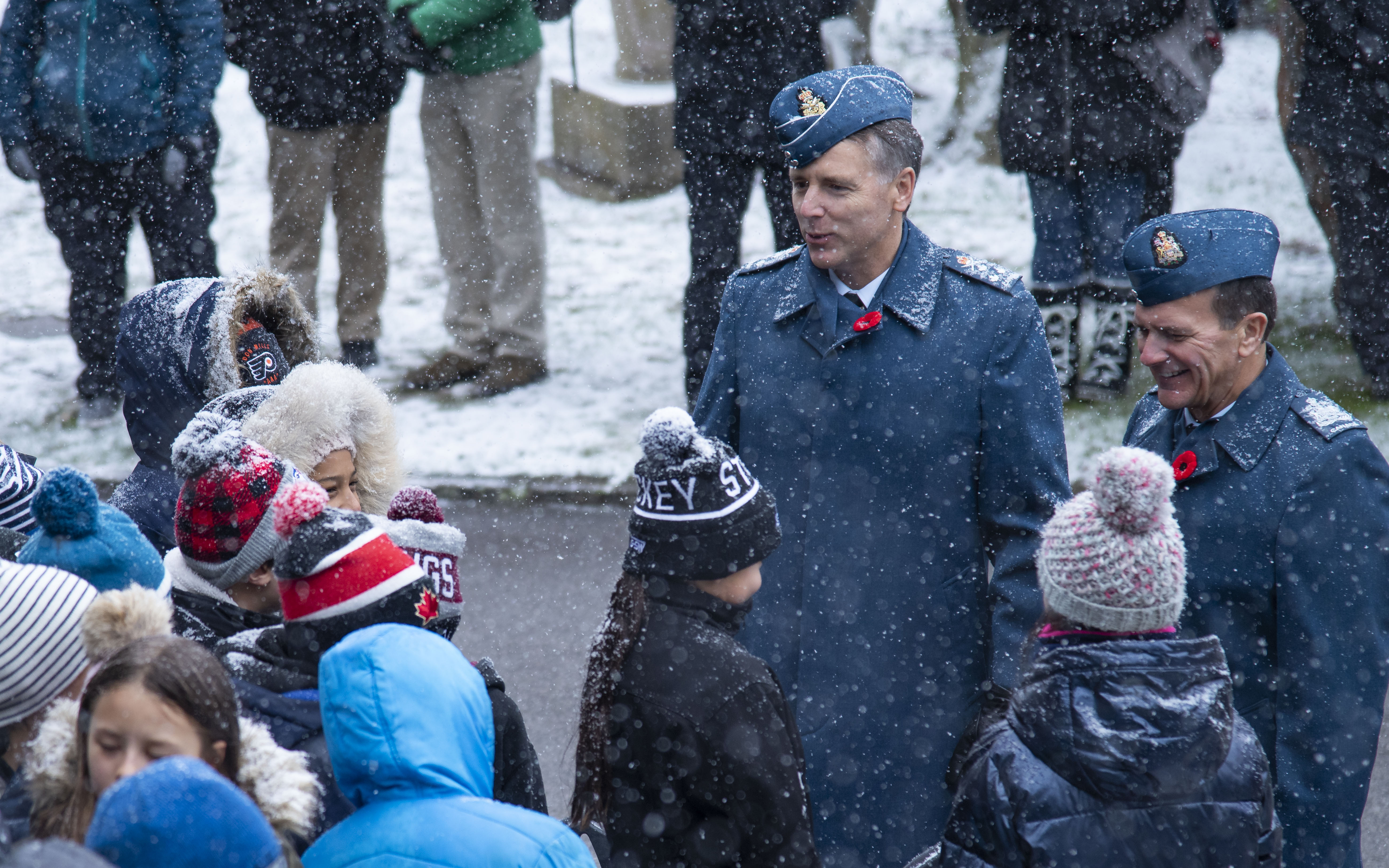 Lieutenant-General Al Meinzinger (left), commander of the Royal Canadian Air Force, and Chief Warrant Officer Denis Gaudreault, command chief warrant officer of the RCAF, talk with students before a Remembrance Day ceremony on November 11, 2019, held at the Mount Pleasant Cemetery, Toronto, Ontario. PHOTO: Corporal Lynette Ai Dang, BM10-2019-0359-005