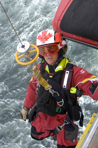 Keith Mitchell, alors adjudant, travaillant en contrebas d’un hélicoptère Cormorant pendant des exercices du 413e Escadron de transport et de sauvetage, en 2008. PHOTO : Archives du MDN