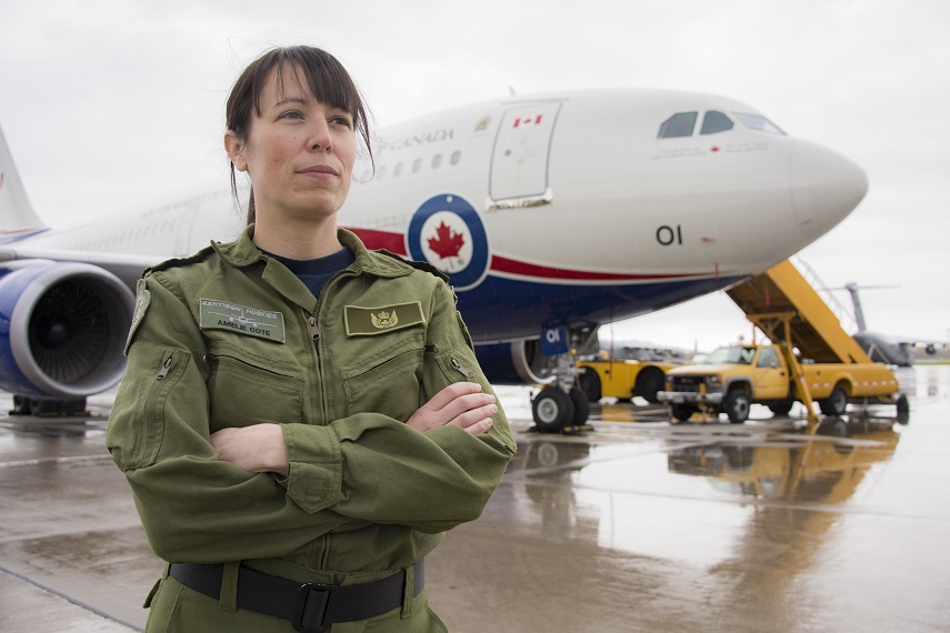 A woman standing in front of an RCAF airplane