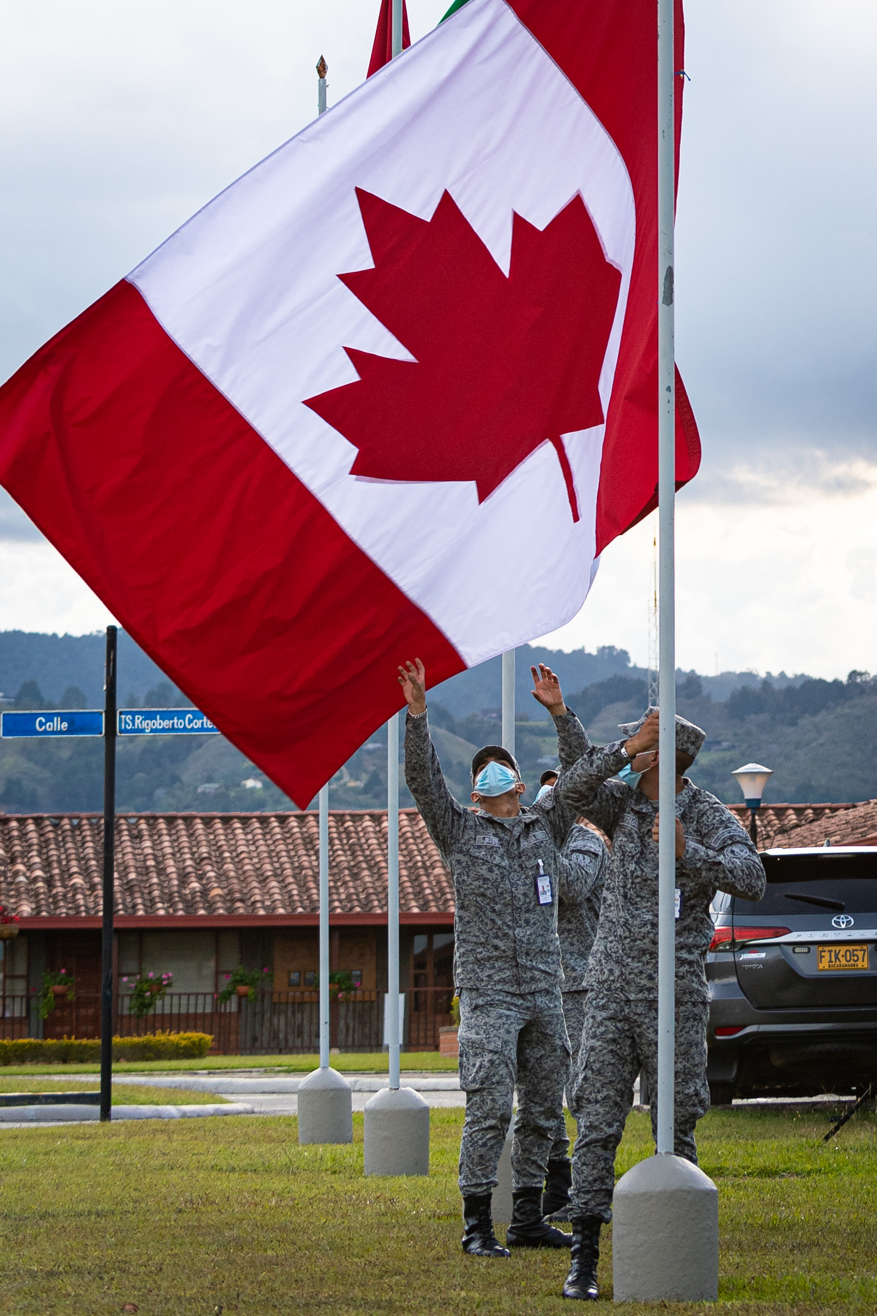 Members of the Colombian Air Force lower the Canadian flag at the end of the day during Exercise COOPERACION VII at Arturo Lema Posada Air Base in Colombia on 3 September 2021. PHOTO: Corporal Dominic Duchesne-Beaulieu