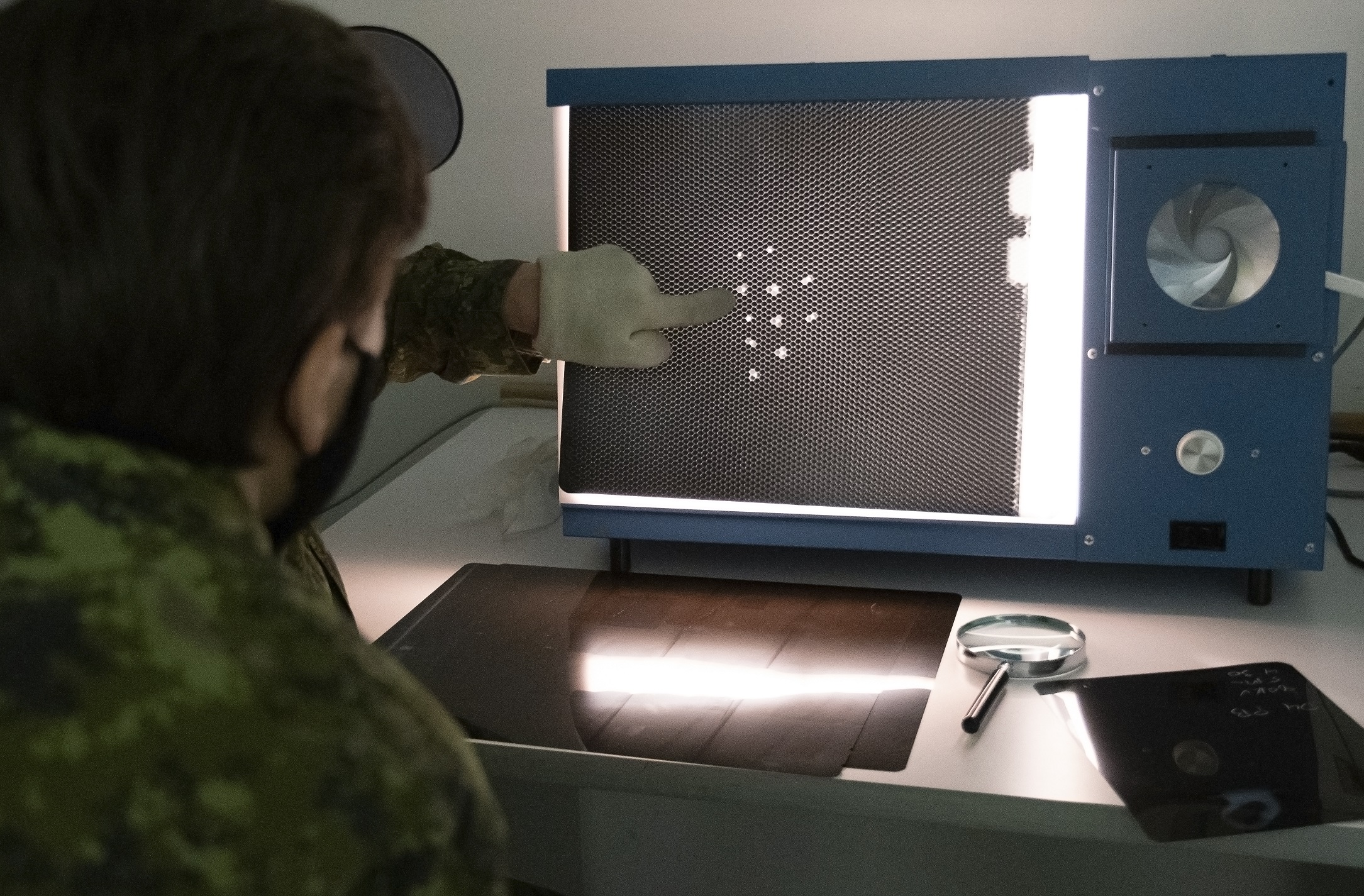 Taken in ATESS NDT Film viewing room. Interpreting Xray image of honeycomb core structure (used primarily in Aircraft flight controls) looking for Core damage, Water ingress or other defect in the flight control core. Cpl Eddy Ford, 8 AMS NDT Support 
Cpl Maggie Selley, ATESS, NDT TRG and DEV