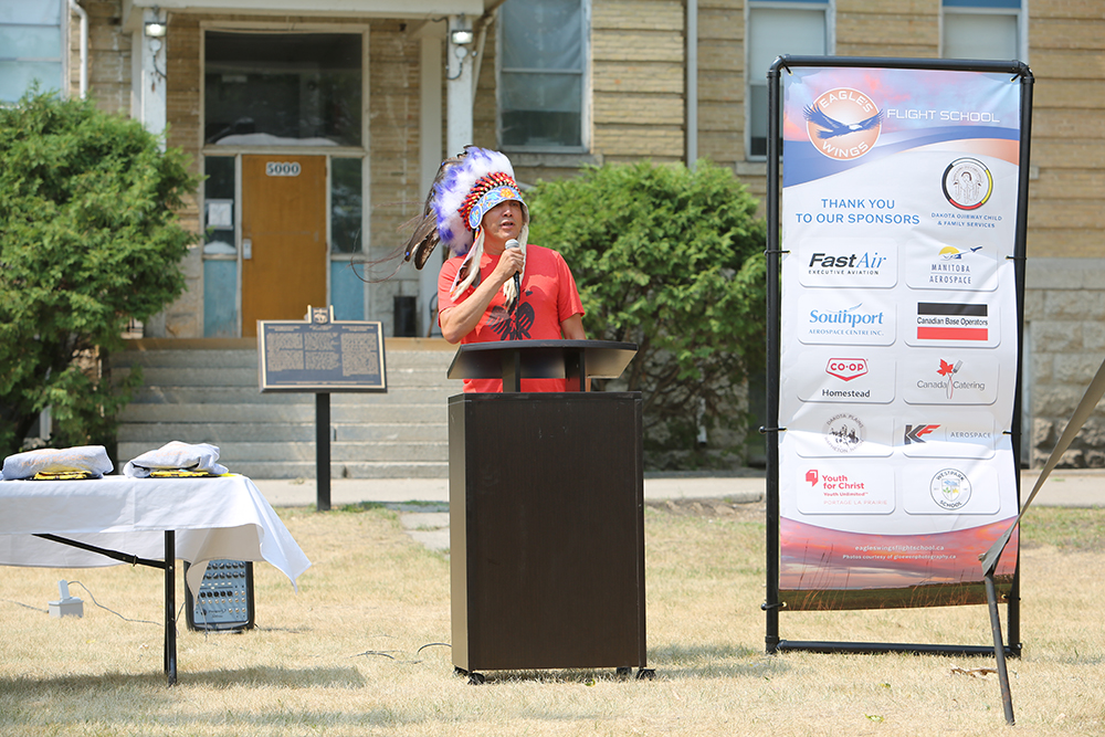 Chief Dennis Meeches, Long Plain First Nation, welcomes guests to the Eagles’ Wings graduation ceremony, held on the lawn of the Rufus Prince Building (former Portage la Prairie Residential School) on the Keeshkeemaquah Reserve in Portage la Prairie. Photos courtesy of Eagle’s Wing