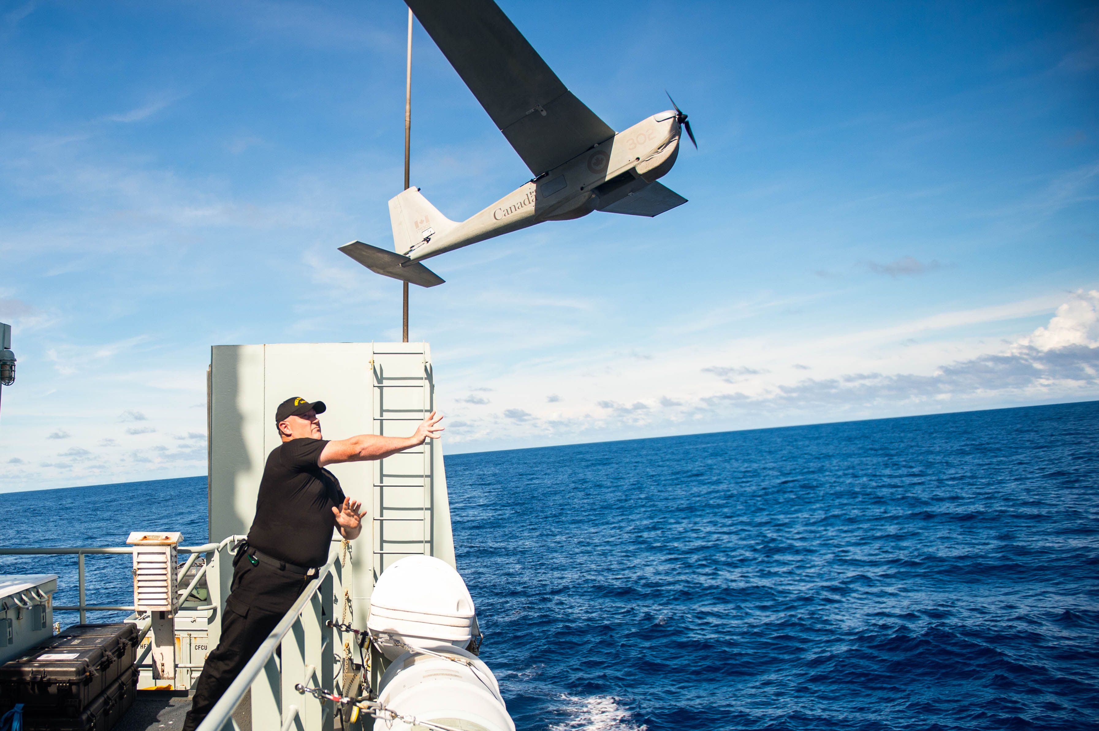 A Royal Canadian Navy member launches a Puma unmanned aerial system
