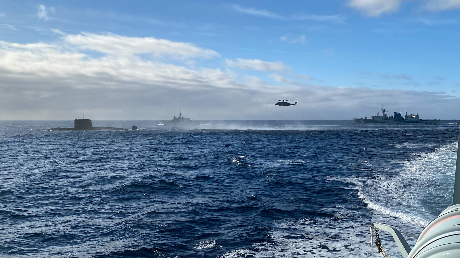 HMCS Victoria, HMCS Saskatoon, HMCS Regina and an RCAF Cyclone helicopter at sea