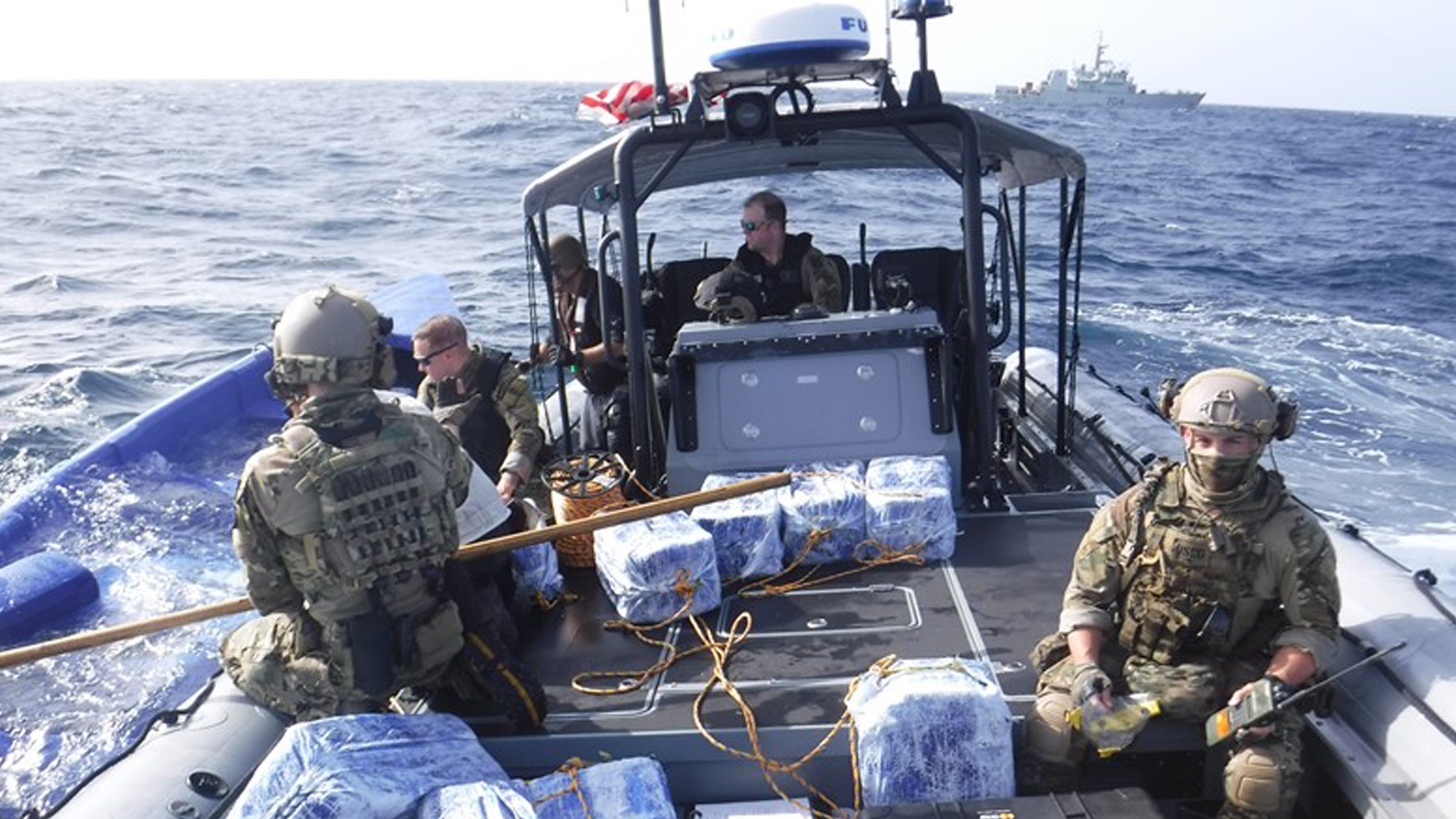 Members of the USCG finish loading seized narcotics onto their Rigid Hulled Inflatable Boat