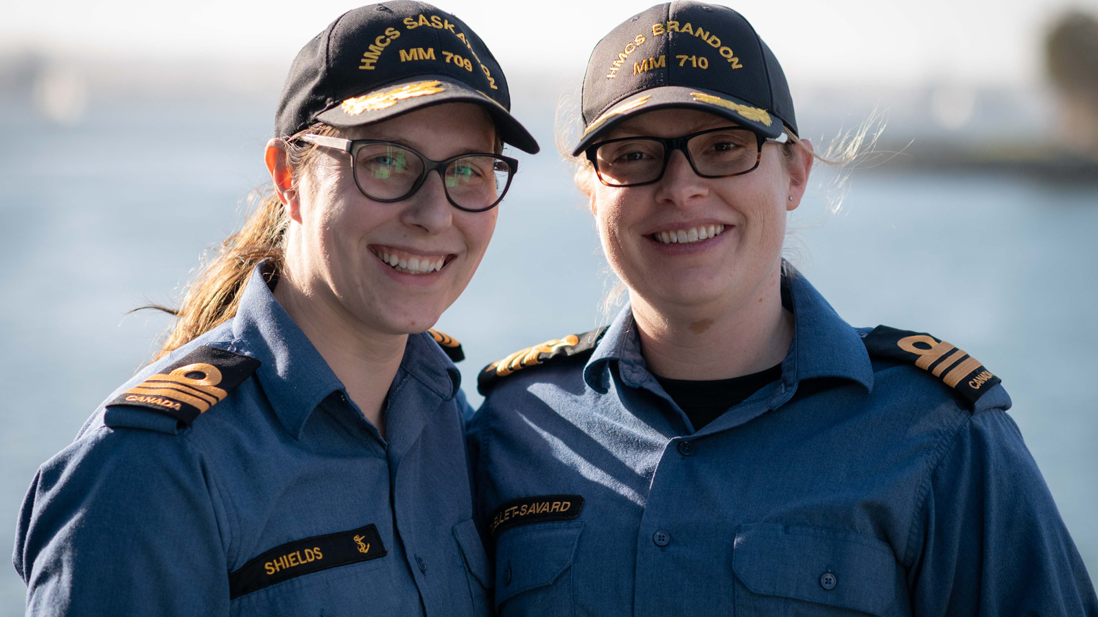 Le Capc Nadia Shields (à gauche), commandant du NCSM Saskatoon et le Capc Maude Ouelette-Savard (à droite), commandant du NCSM Brandon