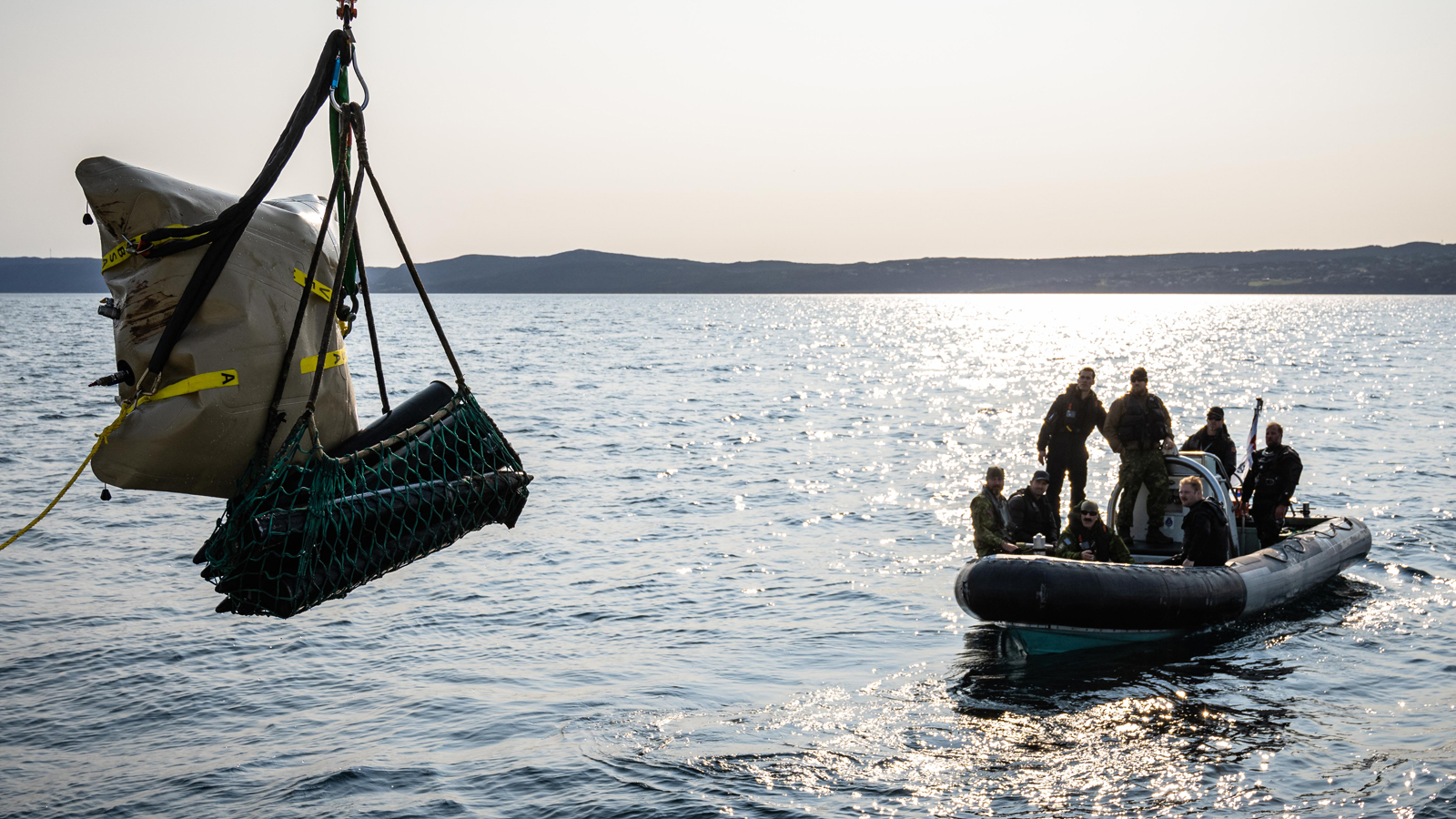 Navy divers lift old ordnance