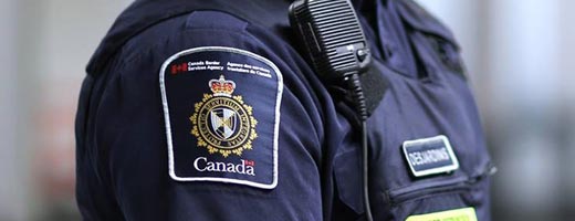 A close-up of a CBSA officer’s badge.