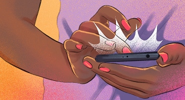 A close-up of a hand holding a smartphone, with light shining from the screen.