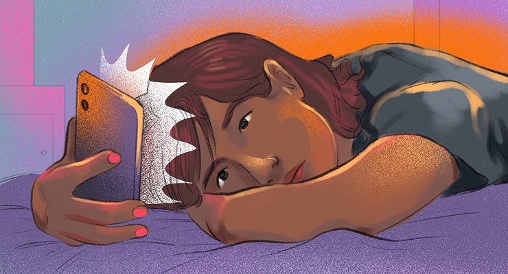 A young woman lying on her stomach on a bed, looking at her phone screen with an upset expression.