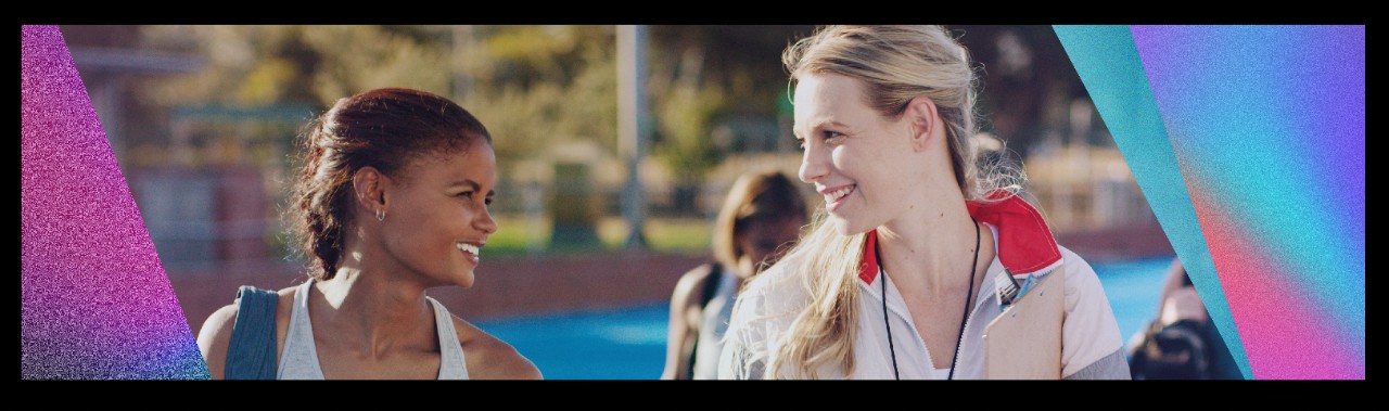 two athletes walking and smiling